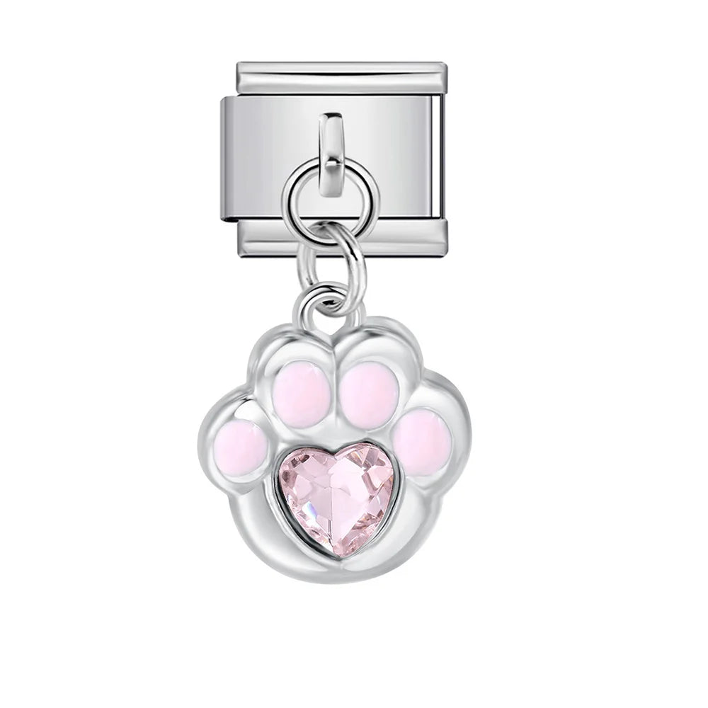 Silver charm with pink paw print and heart on a white background