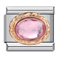 Silver charm with pink gemstone and gold accents on a white background