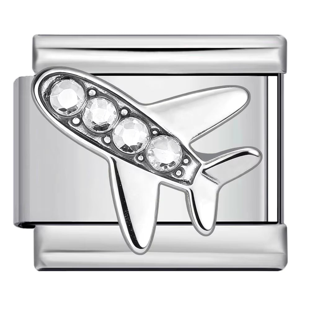 Silver airplane-shaped charm with embedded crystals on a white background