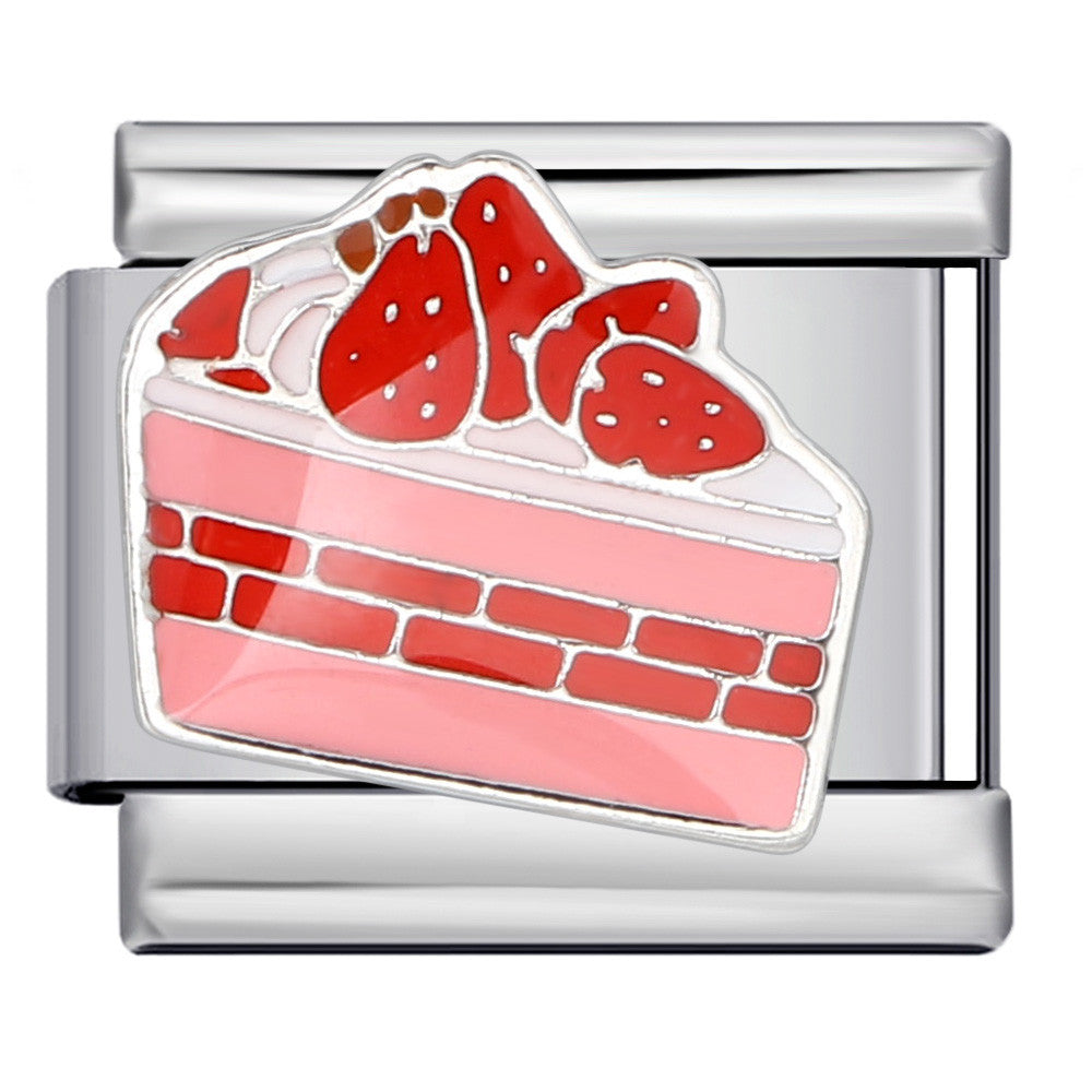silver charm shaped like a slice of strawberry cake on a white background