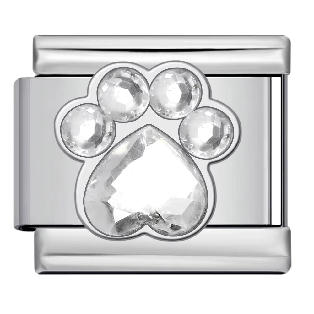 Silver charm with a clear teardrop-shaped gemstone on a white background